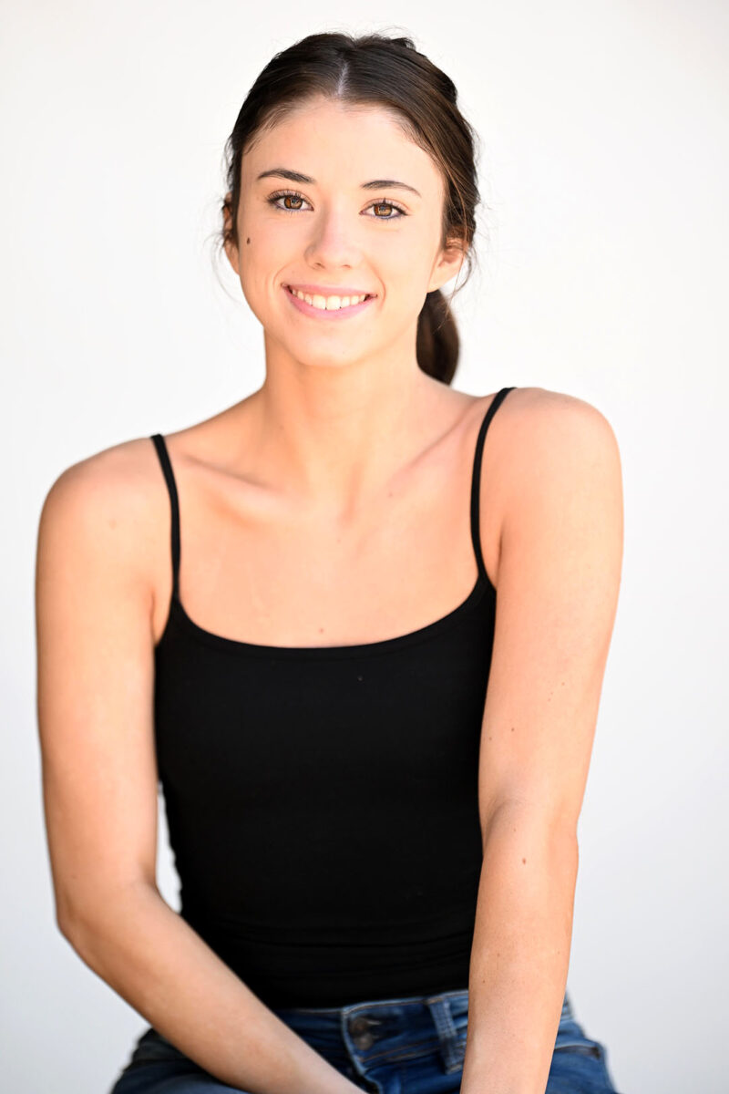 central casting headshot of older teen girl on white background